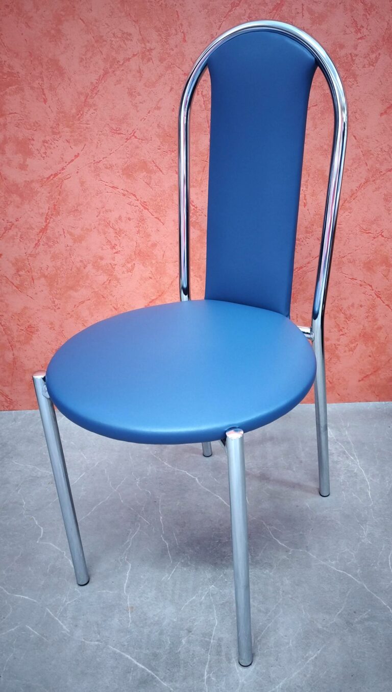 Chaise de cuisine avec une carcasse en métal chromé. Le dossier en forme allongée et l'assise de forme arrondie, sont recouvert d'un skaï bleu.